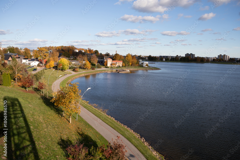 Naklejka premium Panoramic view of Lake Mastis and the lakeside promenade in Telsiai, Lithuania