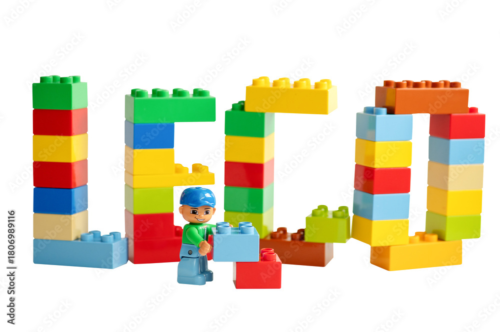 Naklejka premium A Lego minifigure holds toy blocks in front of the 
