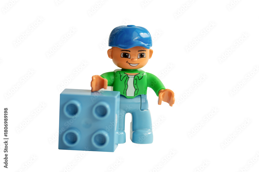 Naklejka premium A studio shot of a Lego minifigure holds toy block isolated on a white background.