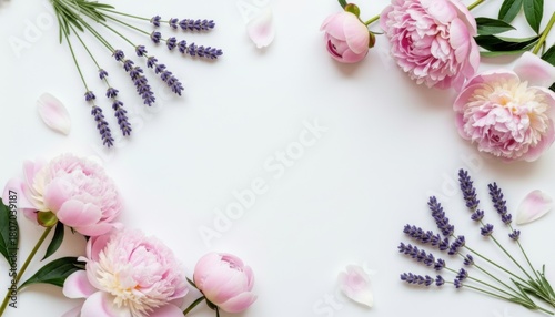 Fototapeta Naklejka Na Ścianę i Meble -  Pink peonies and lavender sprigs surrounding a blank white paper.