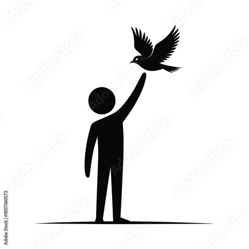 Silhouette of a person releasing a bird into the sky