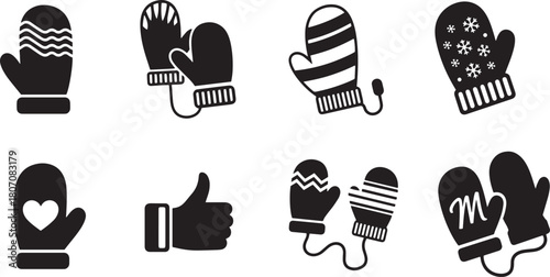 A set of black and white mittens with various patterns and designs, including snowflakes and hearts, against a white background.