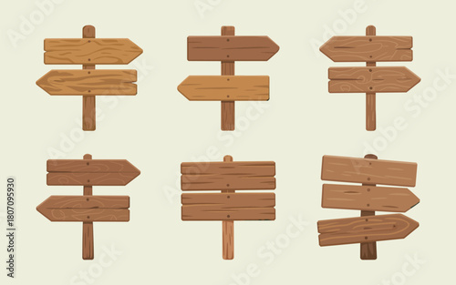 Set of wooden directional signs pointing in different directions on a light background