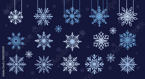 Elegant assortment of various blue and white snowflakes hanging against a dark navy blue background with soft bokeh effects.