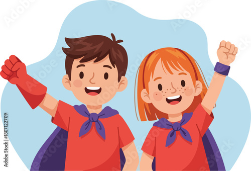 Two cheerful children dressed as superheroes with capes and raised fists.