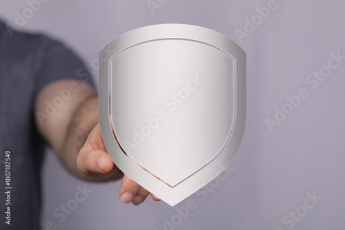 Hand holding a shield, repr...
