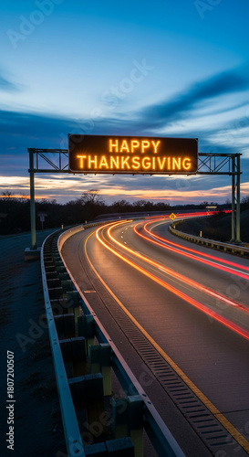 Image of a highway with light streaks from cars at dusk. The sign reads 