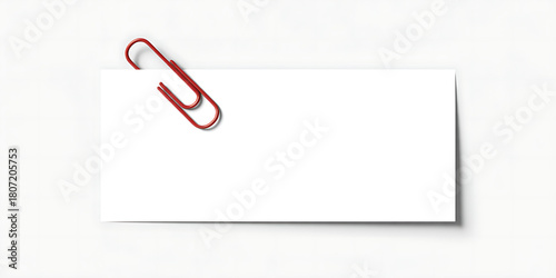 Red paperclip holding a blank white piece of paper isolated on white background