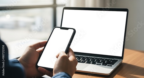 Cell phone and laptop white screen mockup,blank screen while working on laptop at office,Woman hand holding mobile phone Business woman using smartphon