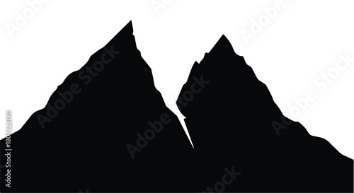 Dramatic silhouette of rugged mountain peaks against a stark background