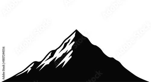 Majestic snow-capped mountain peak silhouetted against a clear sky