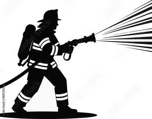 Silhouette of a firefighter spraying water from a hose