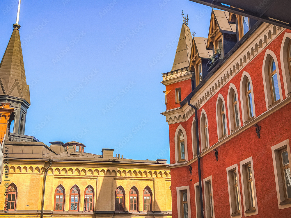 Obraz premium rooftops and building facades in red and yellow colors in central Stockholm