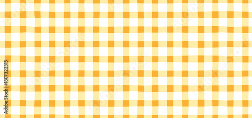  Yellow Vichy checkered seamless pattern in cute childish style. Vector tartan picnic fabric texture for textile design, packaging, wrapping paper, baby clothes, tablecloths, and summer-themed prints

