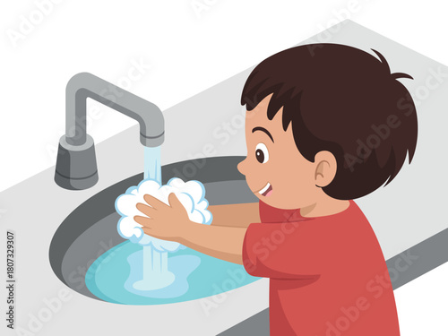 A young boy washes his hands with soap and water in a sink.