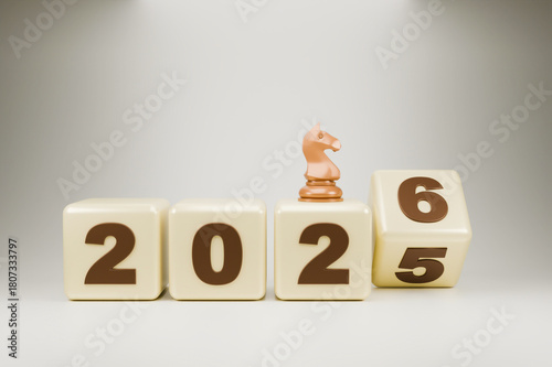 The wooden blocks display the year 2025-2026, with a small chess piece