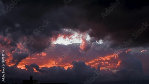Colorful clouds at sunset. Red, orange and grey clouds on the sky.