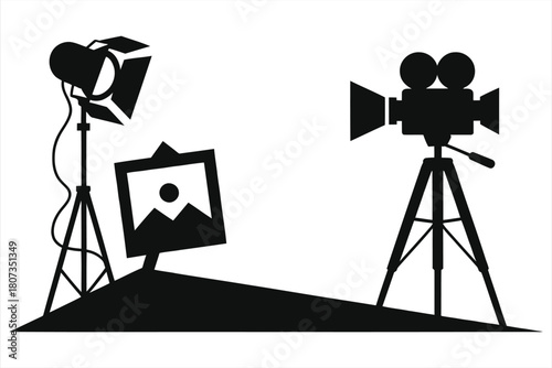 Cinema production vector icon. Silhouette of movie camera on tripod, studio spotlight, and picture frame. Filmmaking, video recording, and photography equipment symbol isolated on white background.