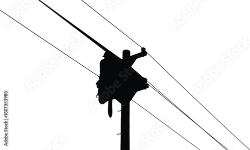 Silhouette of lineman working on power lines
