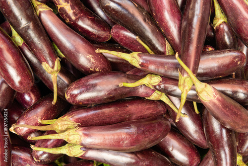 Fresh purple eggplants displayed at a vibrant Kenyan market stall, highlighting nutritious tropical produce and healthy farm-to-market vegetables