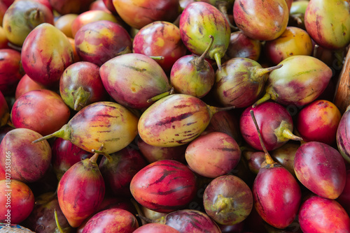 Red Ripe Tamarillo (Tree Tomato) Fruits at a Kenyan Market Stall
Ripe red tamarillos, also known as tree tomatoes, displayed at a Kenyan market stall, highlighting tropical fruit and healthy eating
