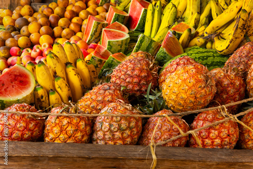 Assortment of Ripe Colorful Fruits at a Kenyan Market Stall
Ripe, colorful fruits including pineapples, bananas, oranges, and watermelon displayed at a vibrant Kenyan market stall