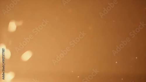 Glowing Light Particles Floating in a Soft Golden Background Creating a Dreamy Atmosphere