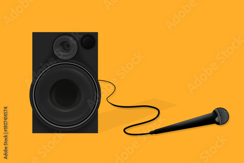 subwoofer speaker and wired mic isolated on yellow background