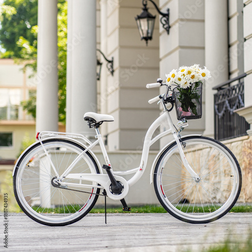 Side view of a modern city urban city bike or bicycle for street road. City bicycle parked on a lawn. Urban bike standing upright on grass, static, no people.