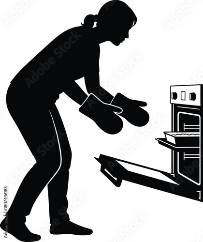 Silhouette of Woman Baking and Taking Food Out of Oven