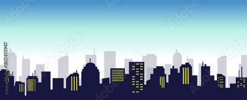 A panoramic silhouette of a city skyline at dusk with illuminated windows against a gradient sky.
