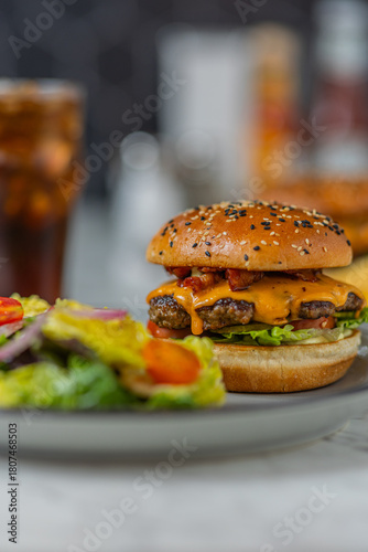 bacon cheeseburger on sesame seed bun in diner hard light