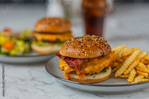 bacon cheeseburger on sesame seed bun in diner hard light