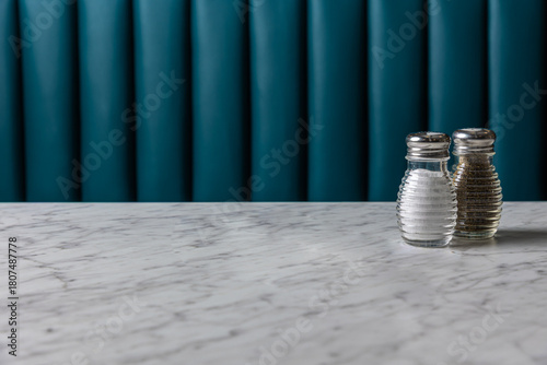 empty table with salt and pepper shakers on marble surface