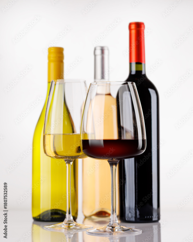Naklejka premium Different wine bottles and glasses on white background