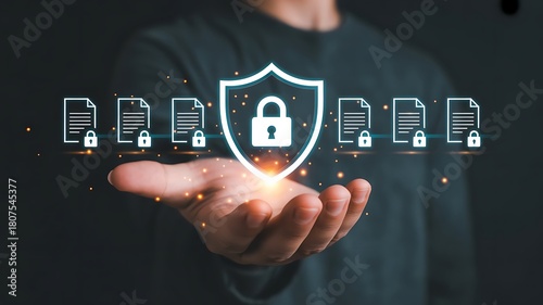 Businessman holding digital shield with glowing lock icon and document symbols representing cybersecurity data protection privacy and secure information management for modern business technology. icon