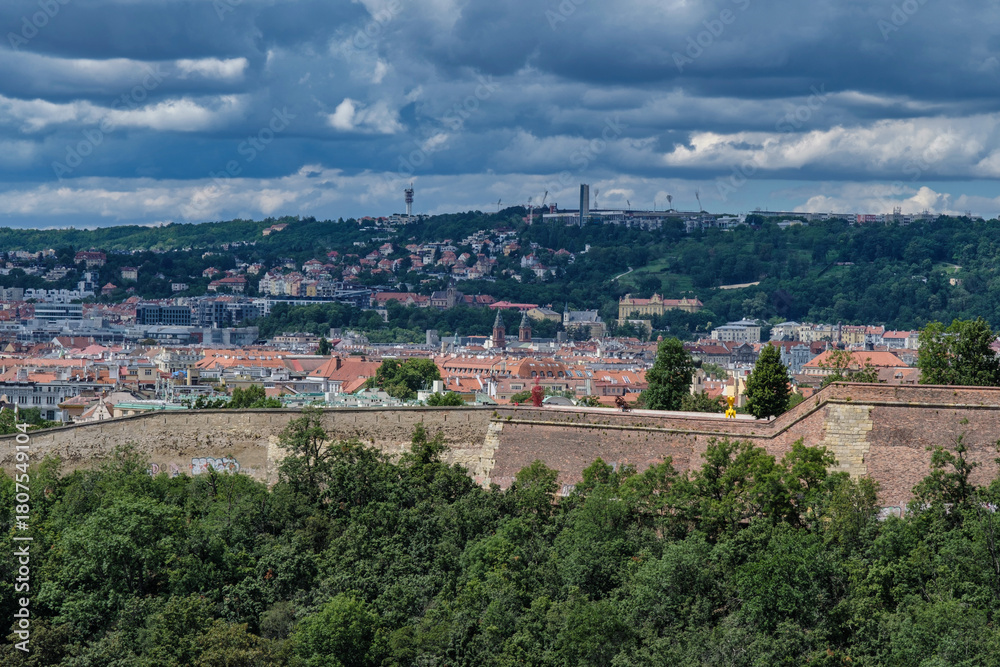 Fototapeta premium Breathtaking panoramic view of Prague, showcasing its historic city center with iconic buildings, charming red-roofed houses.