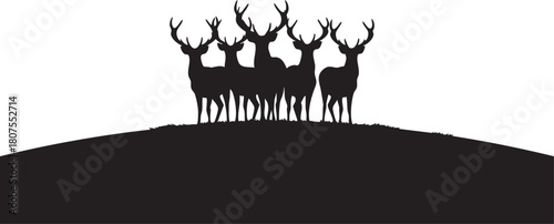 Silhouette of a herd of deer standing on a hill isolated on