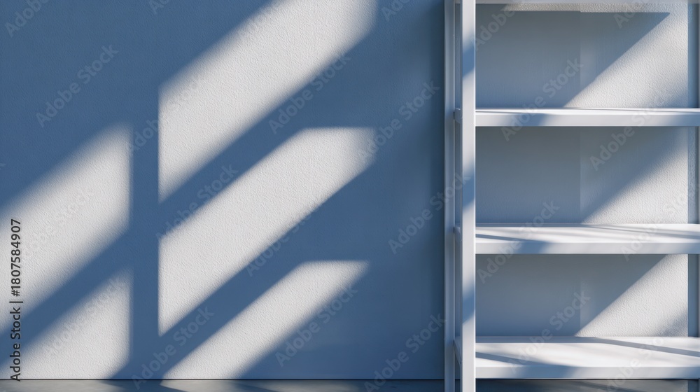 Obraz premium Minimalist interior featuring a white shelf against a blue wall with dramatic shadows in the background