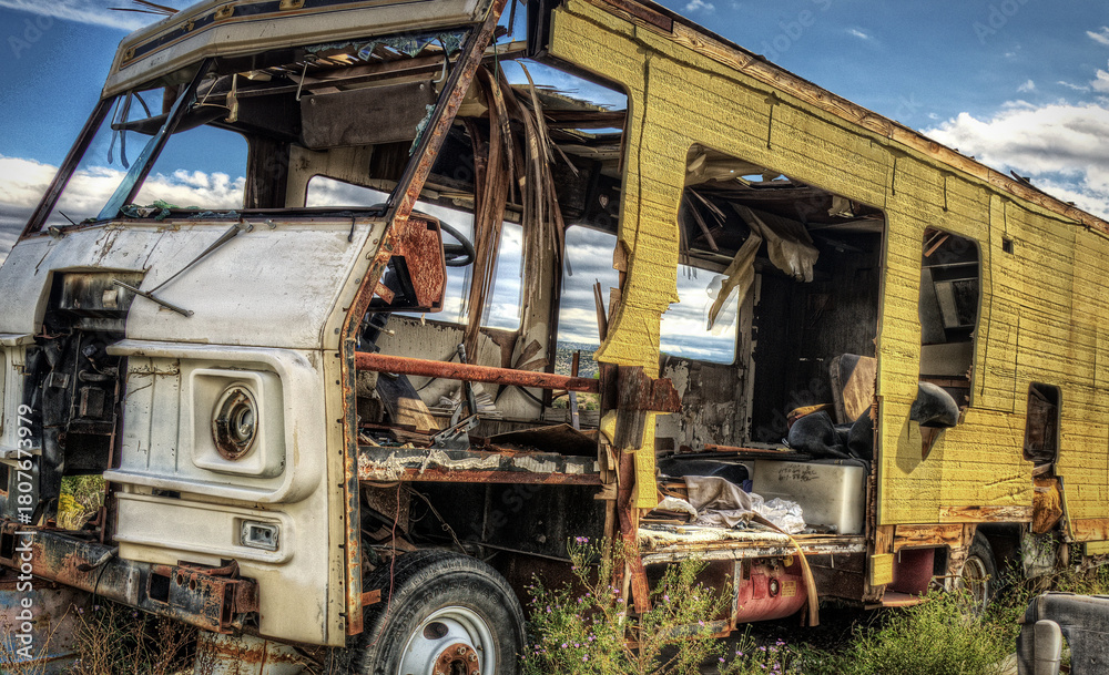 Fototapeta premium Deteriorated RV motorhome was once a vacation road trip family camper now wasting away