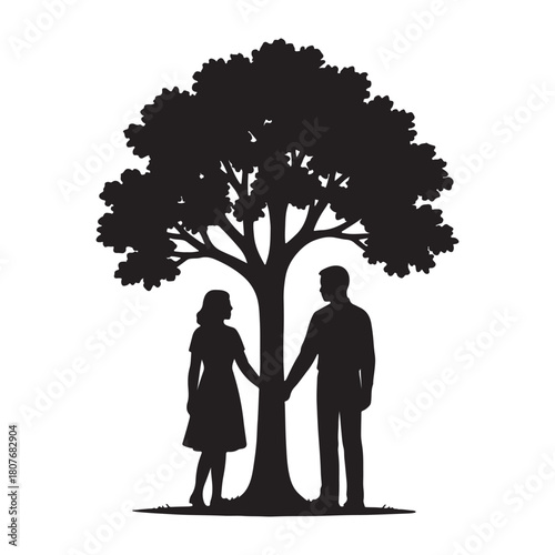 Couple standing hand in hand beneath the silhouette of a large tree representing love and togetherness