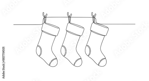 Three Christmas stockings hanging on hooks for festive decoration  