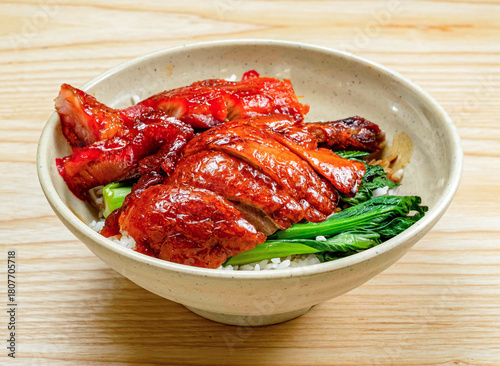 delicious Cantonese roast duck and pork rice bowl with vibrant green vegetables, a flavorful and satisfying meal for any occasion.