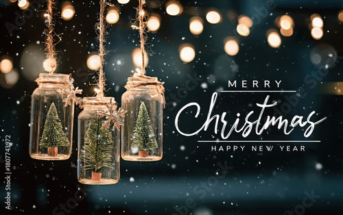 Festive hanging jars with miniature Christmas trees inside against a snowy, bokeh light background.