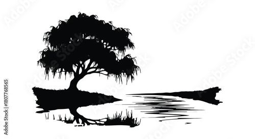 Serene silhouette of a weeping willow tree reflected in calm water at dawn