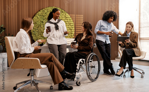 Diverse team having coffee break in modern office