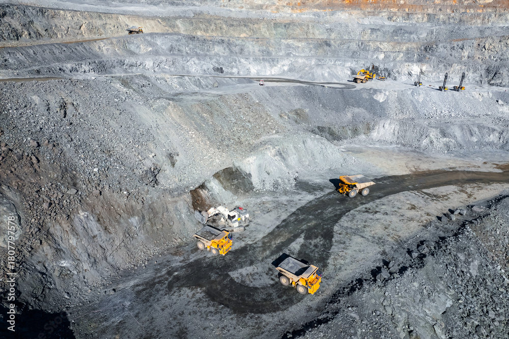 Naklejka premium Open pit mine industry, big yellow mining truck for coal, top view aerial.