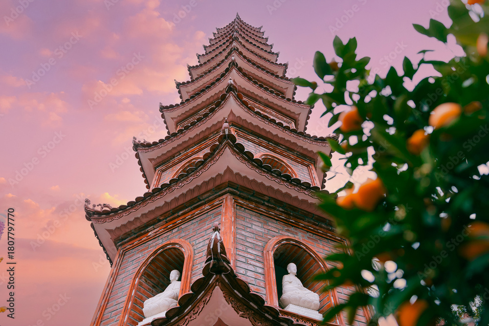 Obraz premium Tran quoc pagoda at sunset, majestic Hanoi landmark against vibrant sky