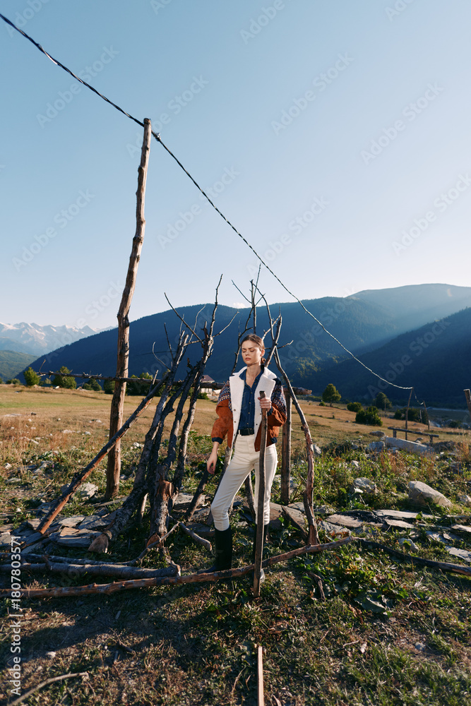 Fototapeta premium Violin man mountains meadow fence musician outdoors landscape standing with instrument in rural valley, portrait in natural sunlight, scenic travel and creative music lifestyle image
