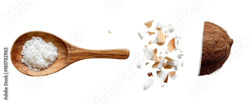 Wooden spoon filled with shredded coconut, next to a half coconut
